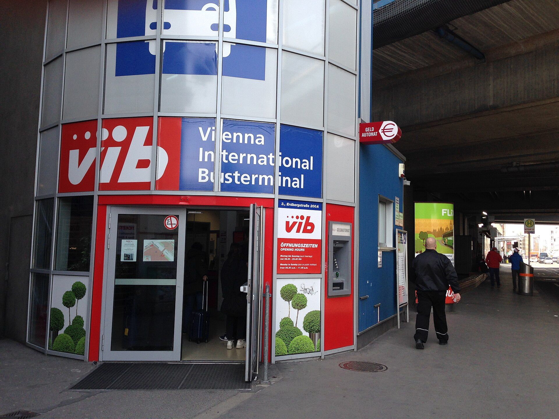 Ticket office entrance of the Vienna International Busterminal at Erdberg, with its opening-hours board beside the door