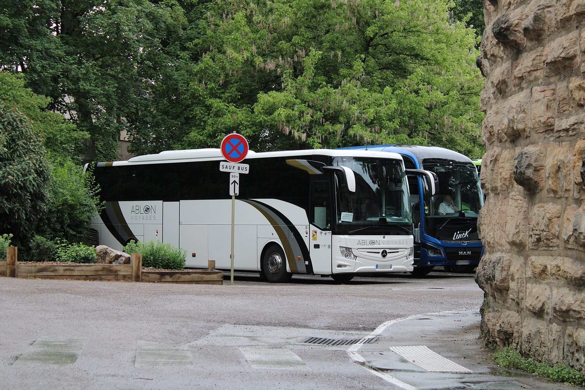 Mercedes-Benz Tourismo and MAN Lion's Coach parked side by side in Beaune, France