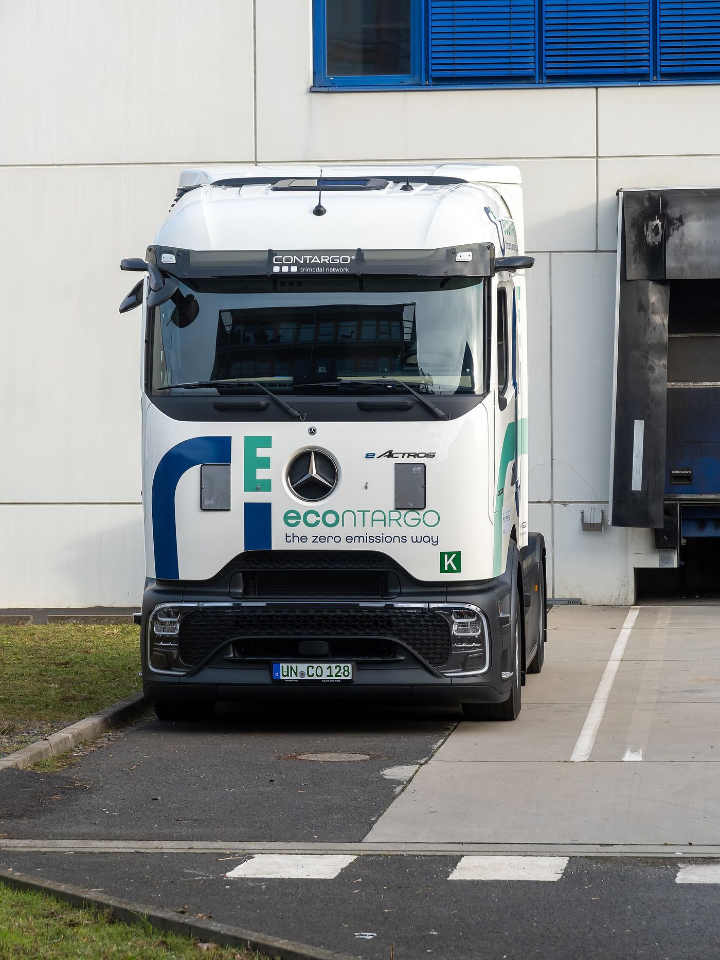White Mercedes-Benz eActros tractor unit in econtargo livery at a loading dock in Frankfurt