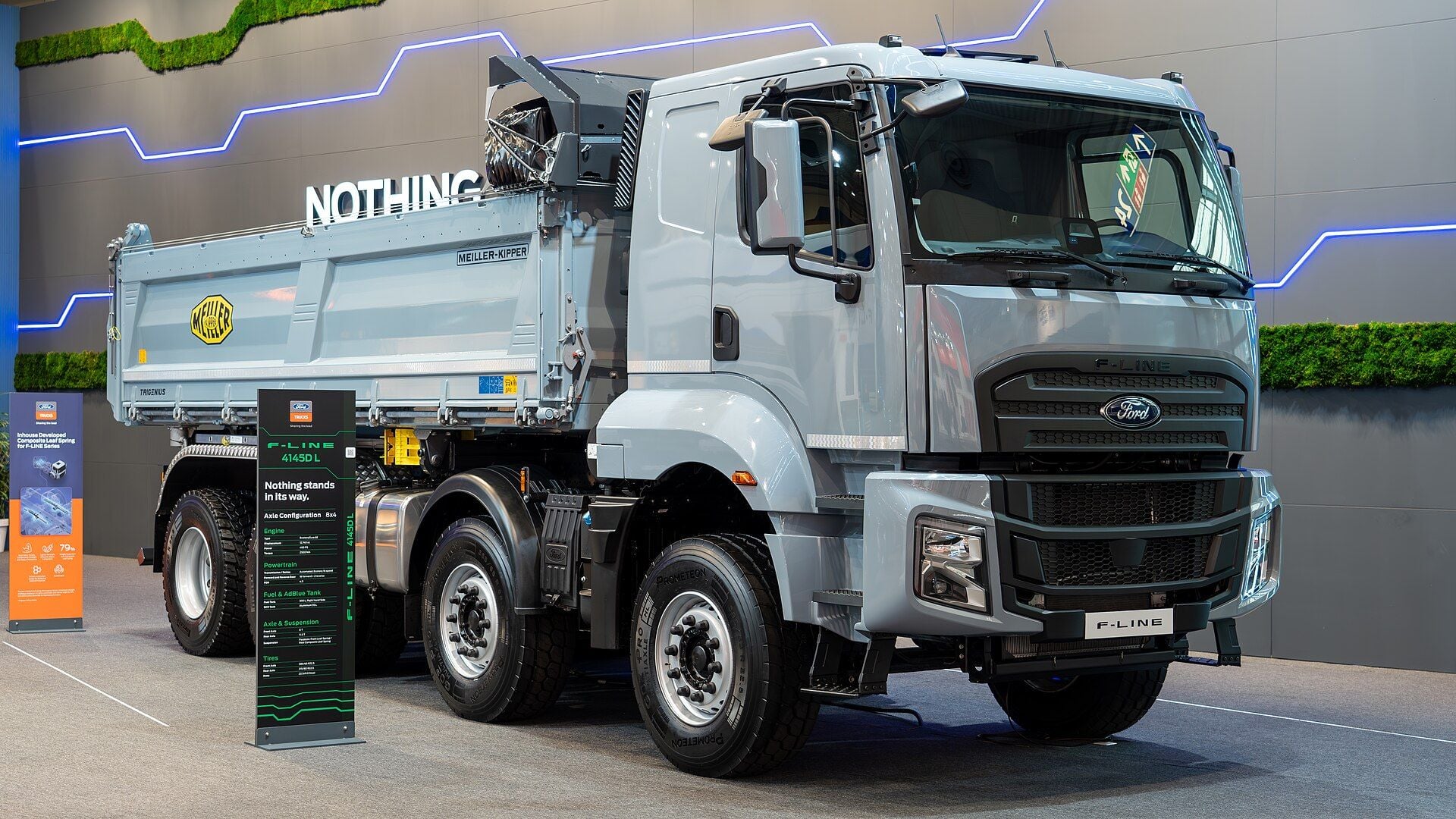 Ribaltabile a otto ruote Ford Trucks F-LINE 4145D L grigio con cabina corta, due assi anteriori e cassone ribaltabile Meiller, sullo stand di Ford Trucks all'IAA Transportation 2024