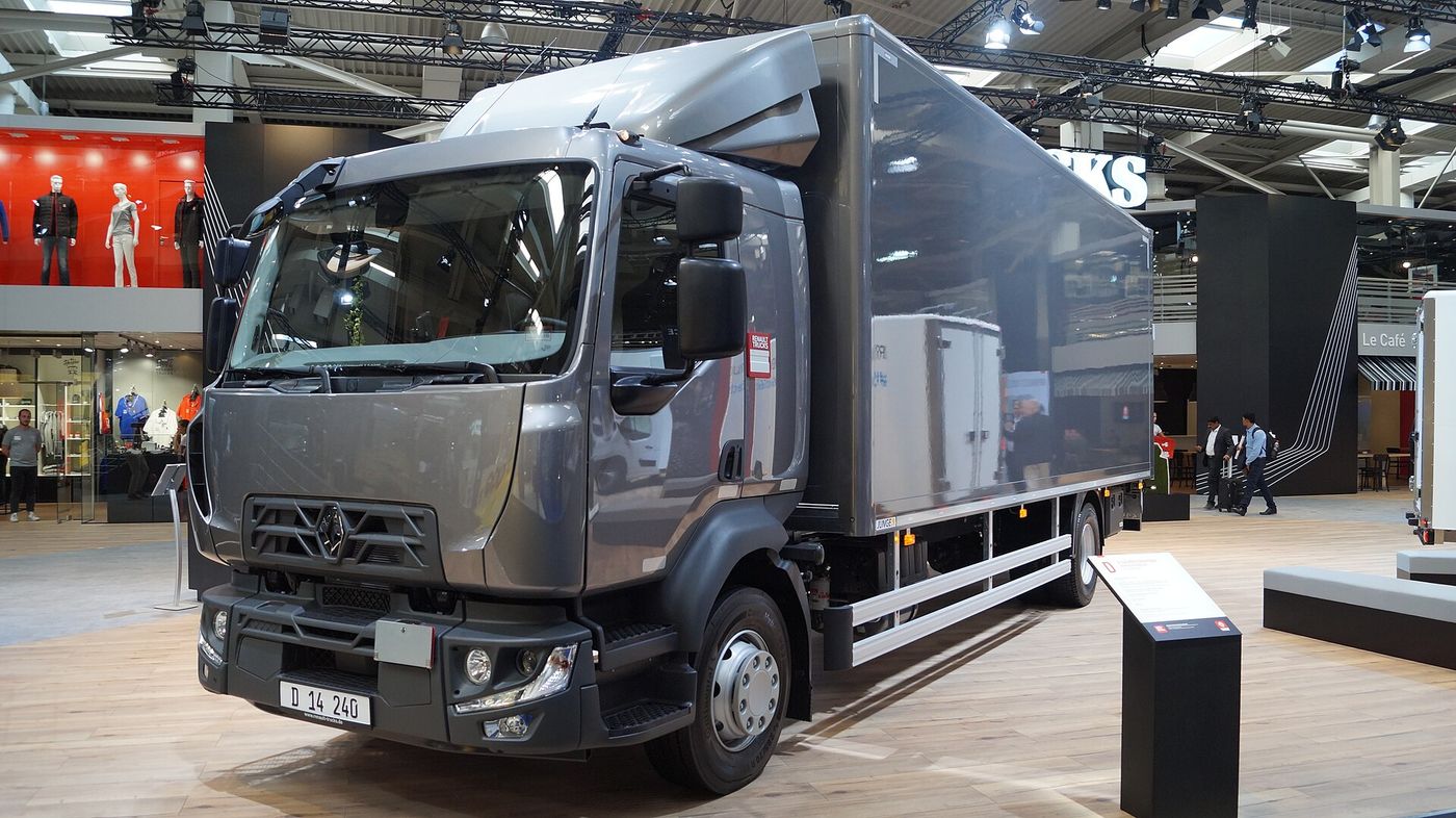 Grey Renault Trucks D 240 two-axle rigid with a box body and a roof deflector, front three-quarter view on Renault Trucks' stand at IAA 2018, in the front design used before the 2023 facelift