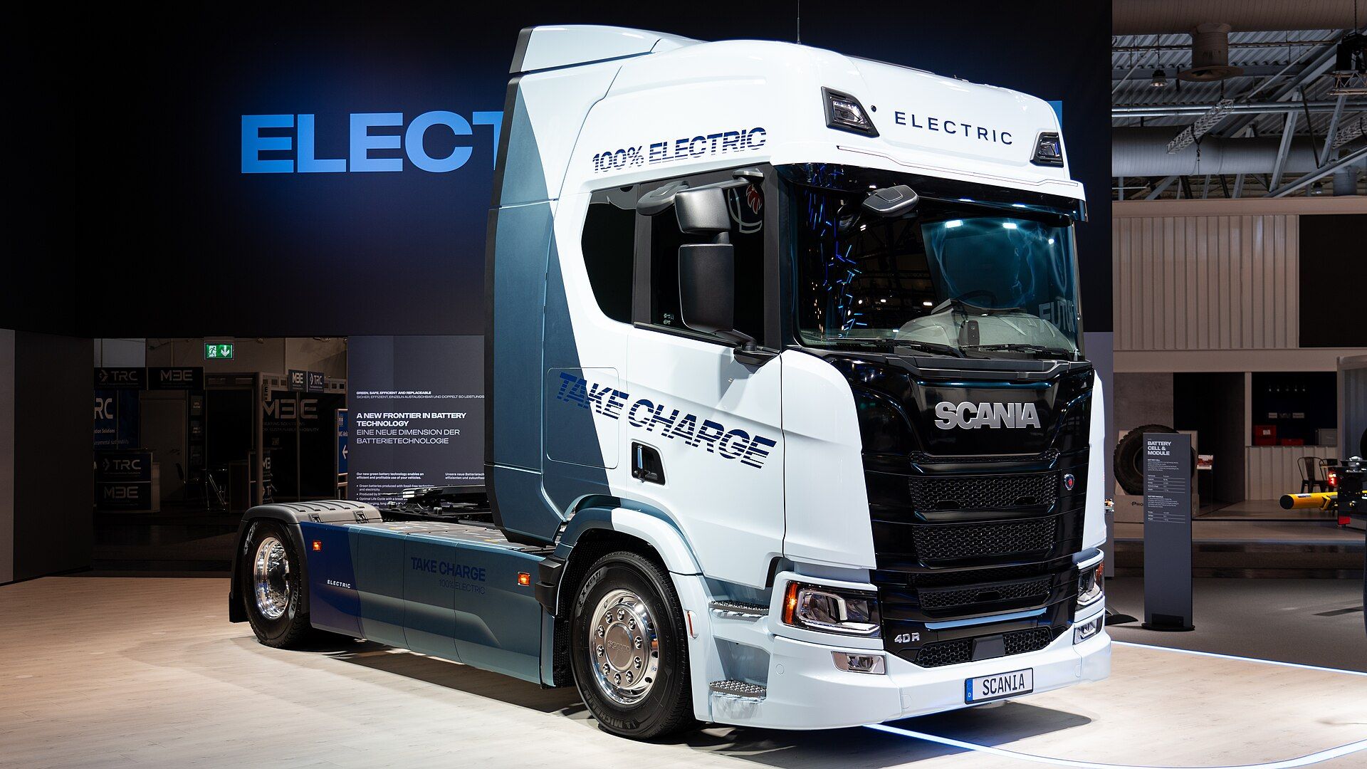 White and blue battery-electric Scania 40 R two-axle tractor unit marked 100% Electric, on Scania's stand at IAA Transportation 2024