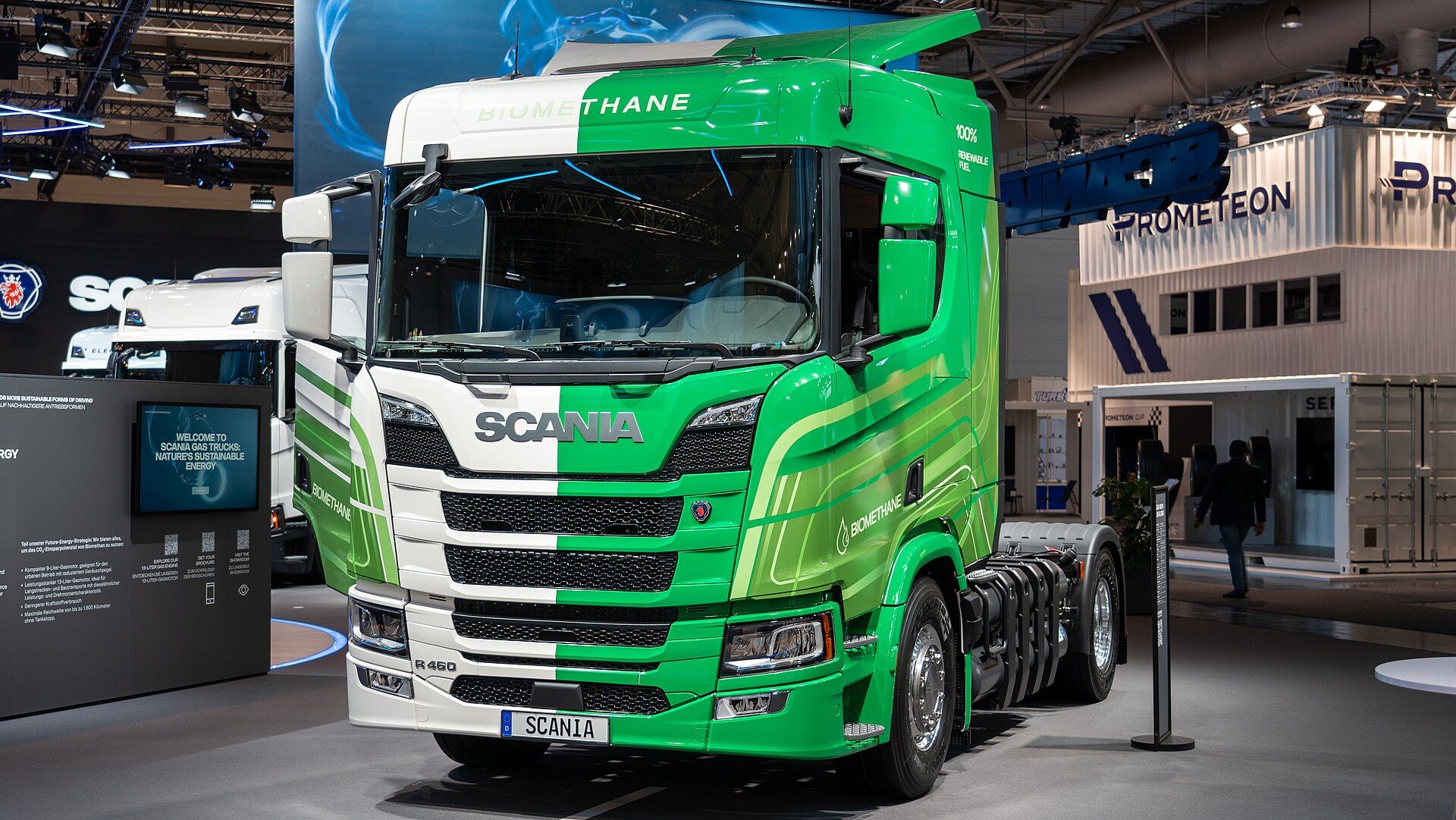 Green and white Scania R 460 biomethane two-axle tractor unit with gas tanks behind the cab, on Scania's stand at IAA Transportation 2024