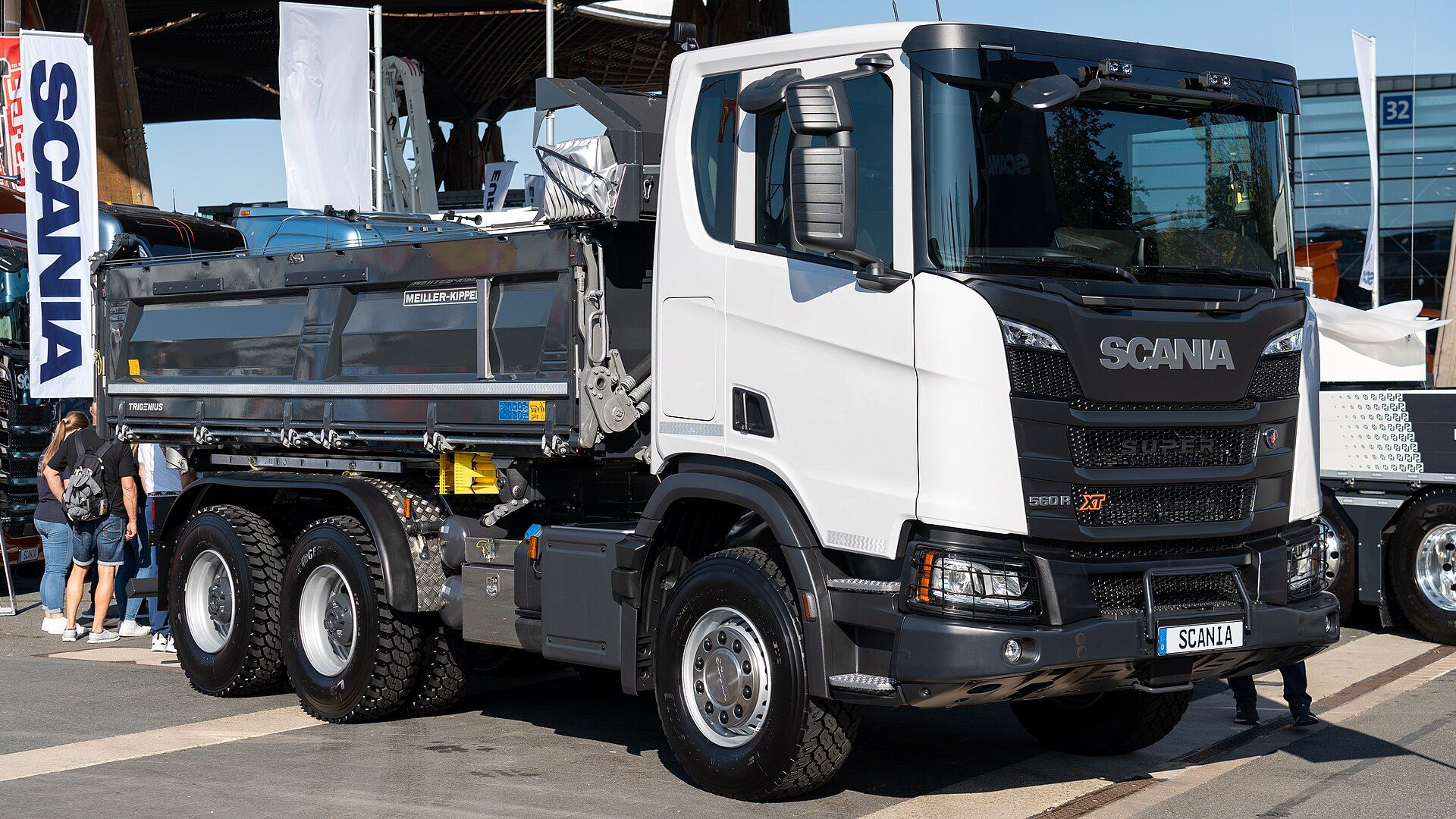 White Scania 560 R XT three-axle tipper with a Meiller body, seen from the front quarter at IAA Transportation 2024