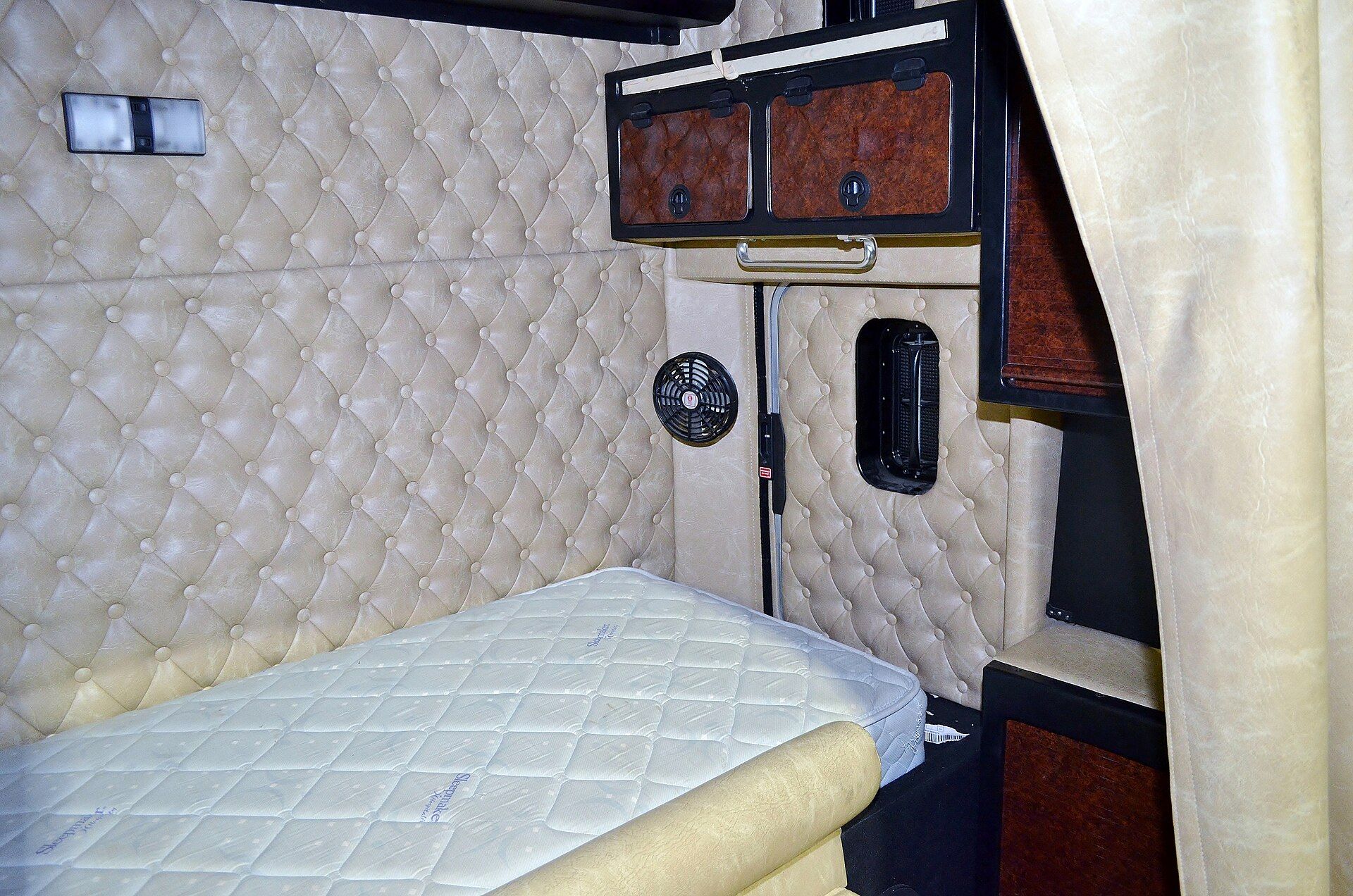 Sleeper area inside the cab of a semi-trailer tractor, seen from the driving position
