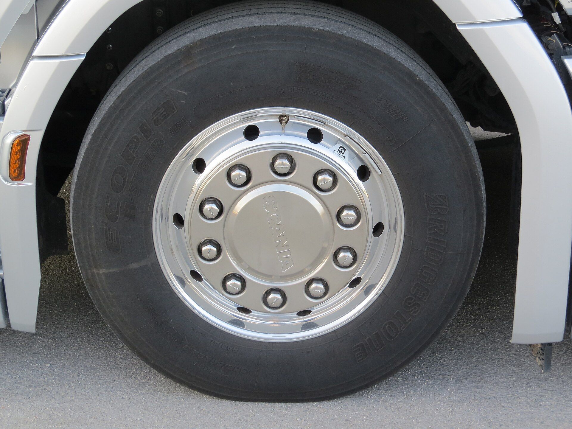 Close-up of a Bridgestone Ecopia H-Steer 001 truck steer tyre on the polished front wheel of a Scania tractor unit