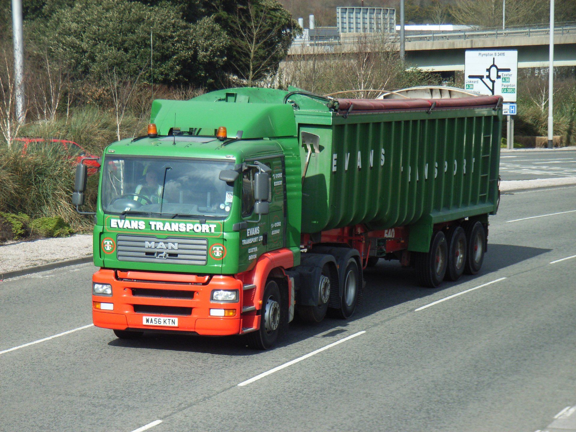 UK-registered MAN tractor unit pulling a tipper semi-trailer along a road at Marsh Mills, Plymouth, England